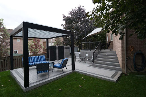 A multi-level deck with a pergola over a seating area.