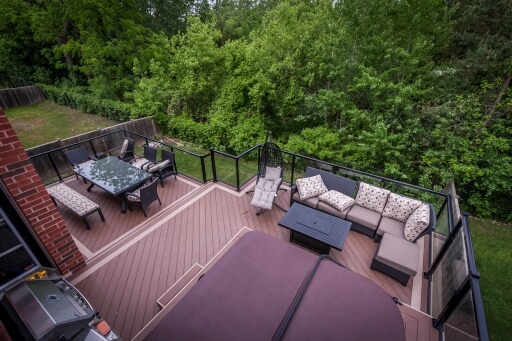 A large deck with seating areas and a hot tub.