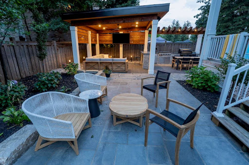 A landscaped backyard with a seating area and covered patio.