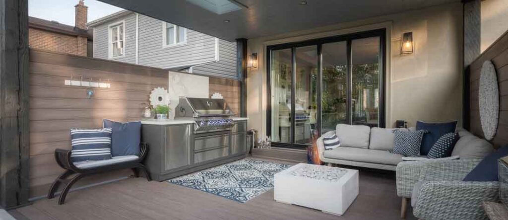 Narrow city backyard with a covered deck and swim spa creating a private urban getaway