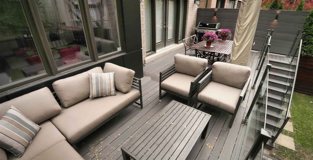 Walkout composite deck in Toronto with dining and lounge areas extending outdoor living