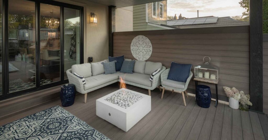Covered deck with a cozy seating area and privacy screens for a fully secluded outdoor space