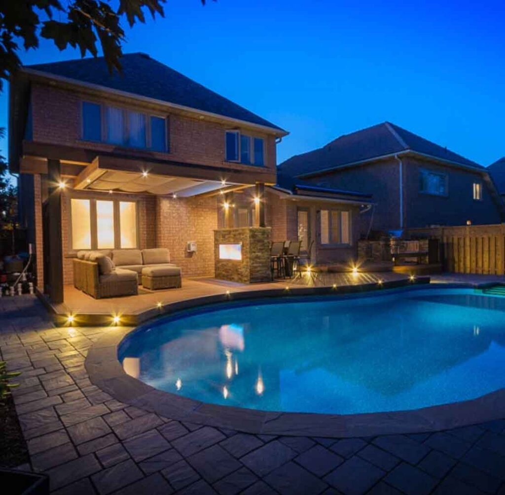 kidney shaped pool with curved deck right upto the edge of poo for a seamless look