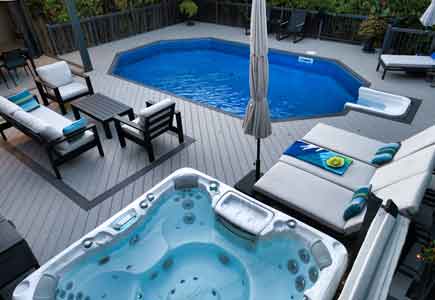 Luxury pool deck in Woodbridge with louvered pergola, retractable screens, hot tub, and private lounging areas