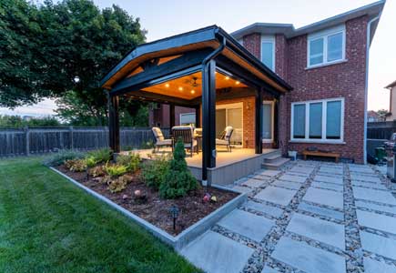 Wolf PVC deck with timber roof, wood ceiling, bug screens, and garden views — Oakville backyard design and build.