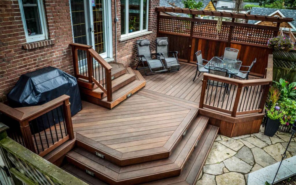 Hardwood Ipe deck with custom decking patterns and privacy screen, designed to complement a traditional Toronto home