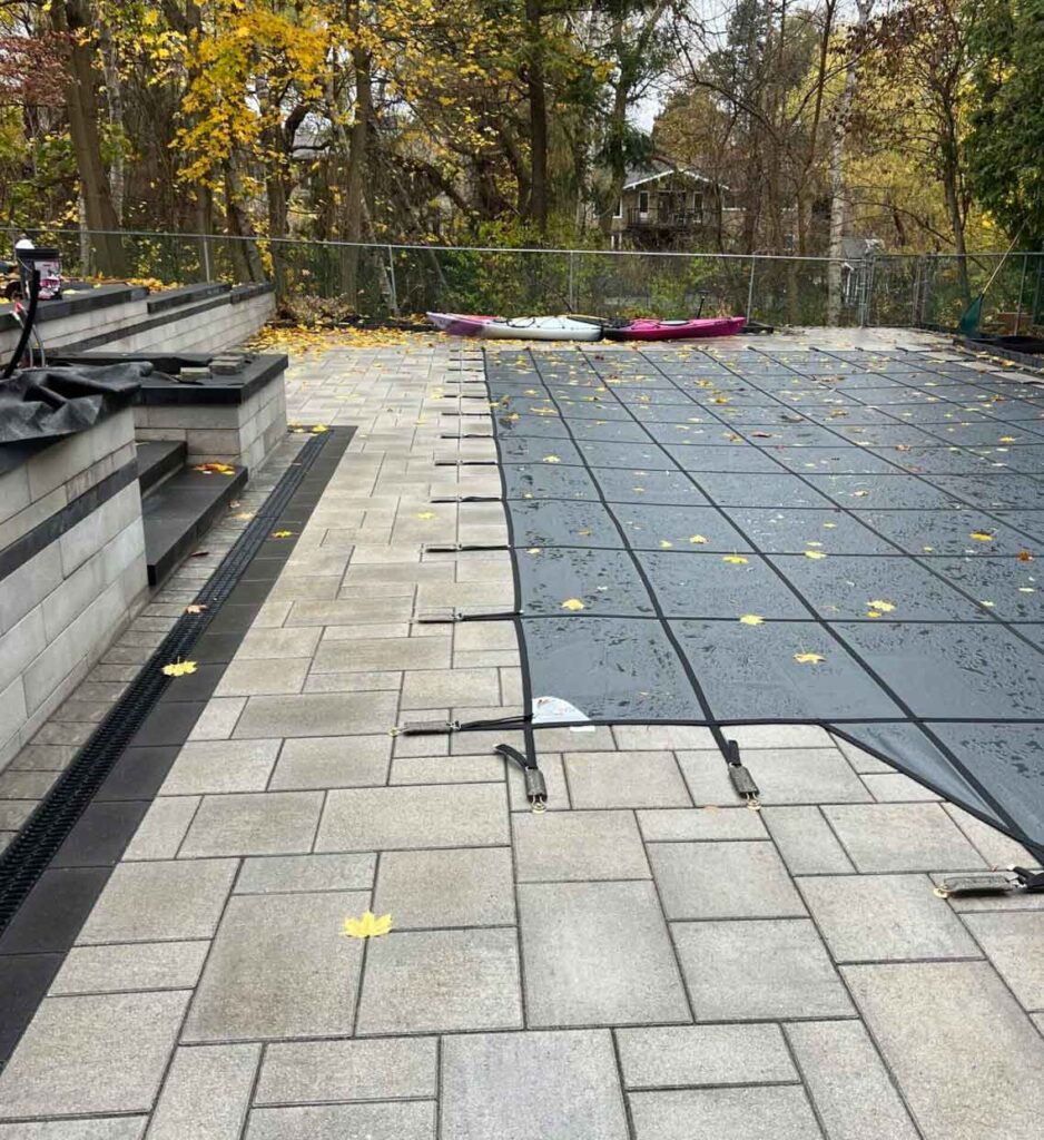 incorporating stone retaining walls into sloped backyards with a pool