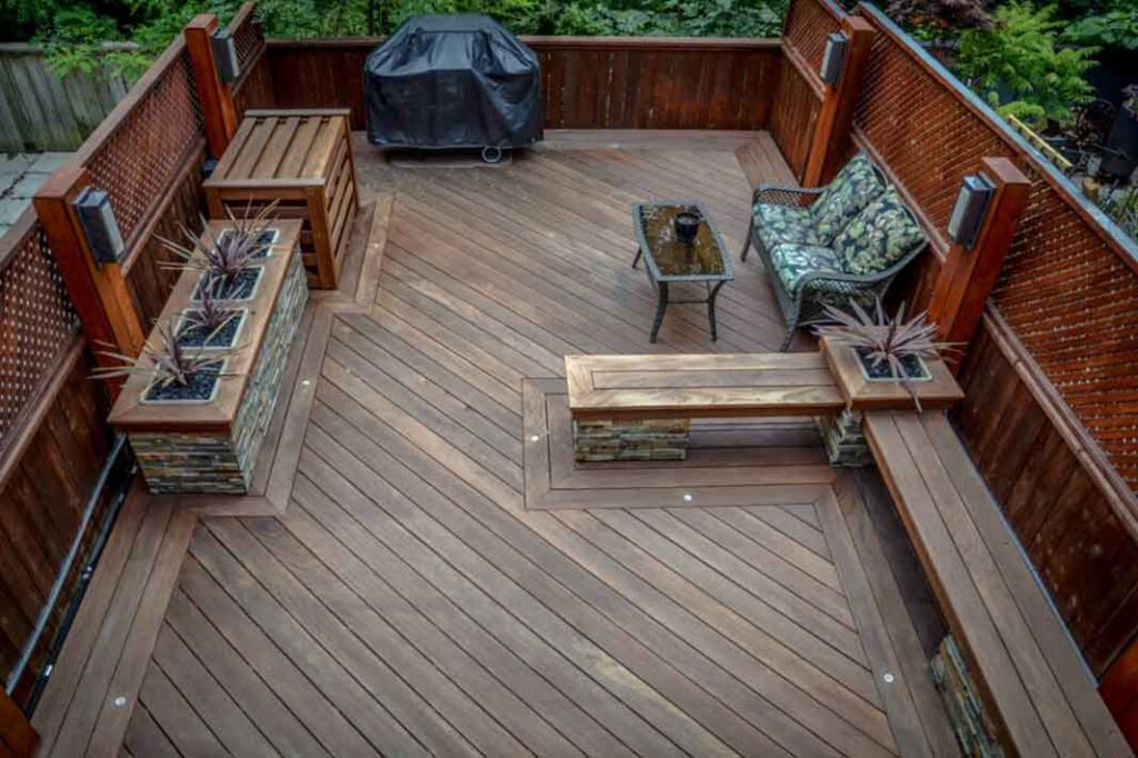 Rooftop deck extending outdoor living space with planters, built-in benches, and lighting