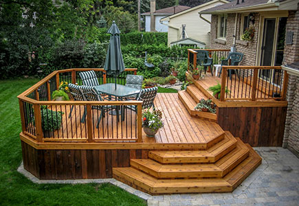 Iconic two-level Burlington deck with upper BBQ area, lower dining level, cut-corner design, and elegant wraparound stairs—ideal for mid-height patio doors.