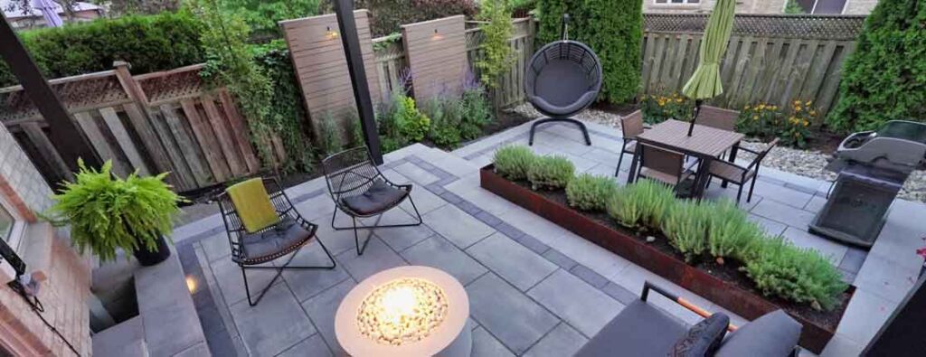 Multi-level stone backyard in a townhome designed as a perfect summer getaway