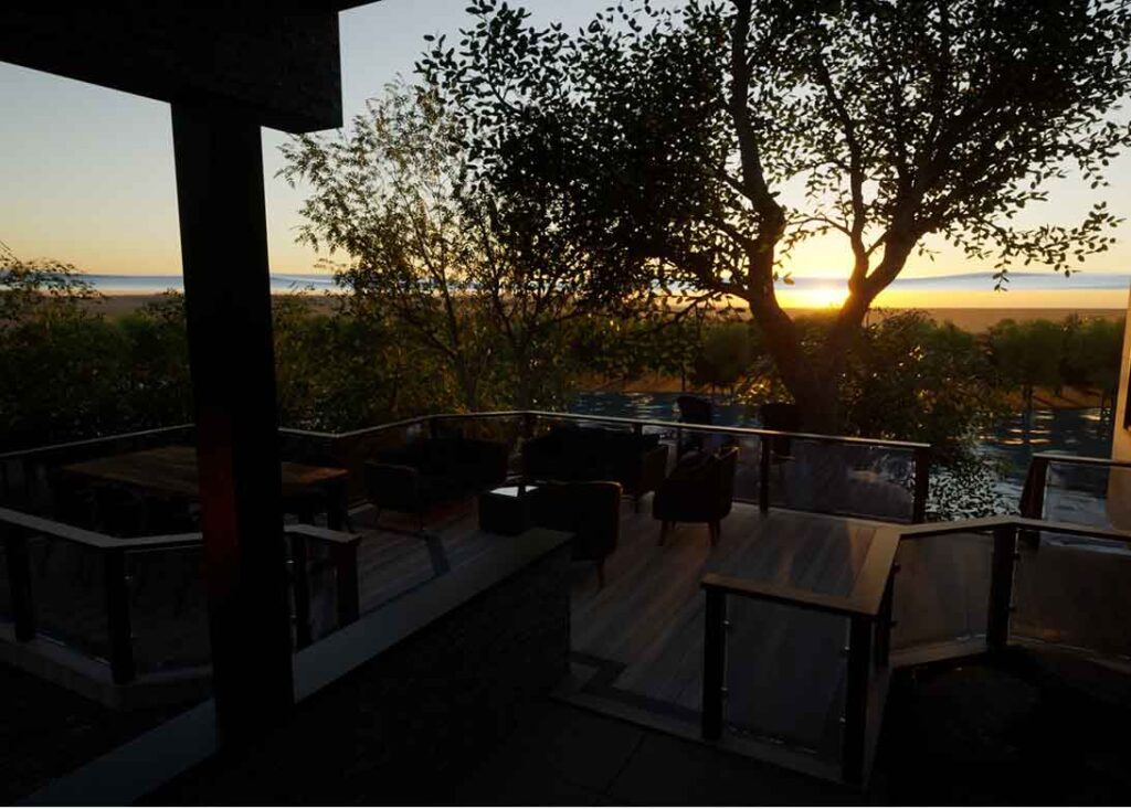 3D rendering of a cottage deck overlooking a lake at sunset, designed as a peaceful spot to unwind and enjoy evening views