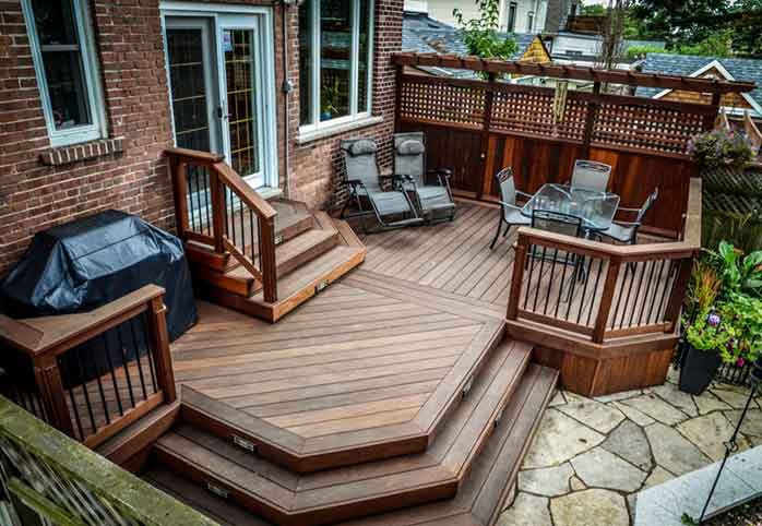 alt for an image for hub page recent project cards , showing pvc second floor deck wtih frameless glass, lighting, multilevel walktou decks