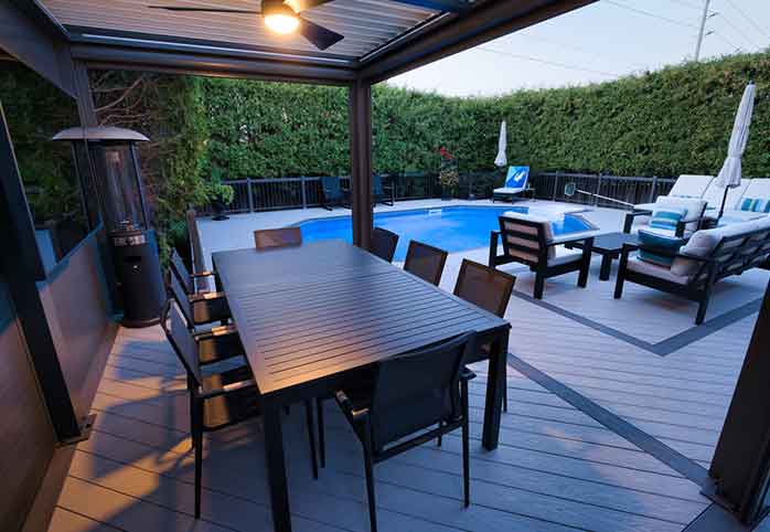 PVC pool deck with louvered pergola and hot tub staycation backyard