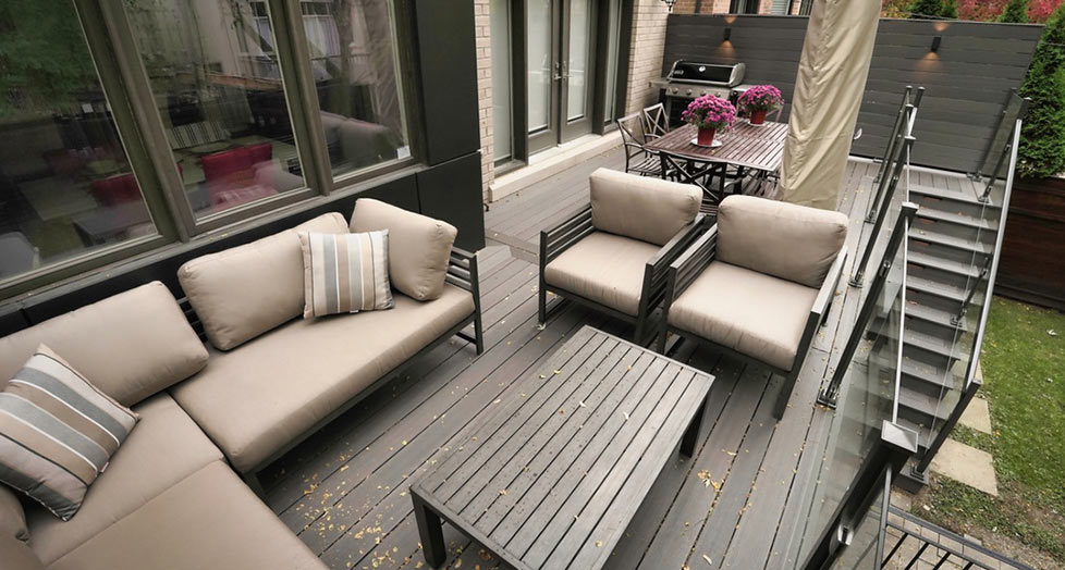Second-floor composite deck in Toronto featuring glass railings and clean modern lines