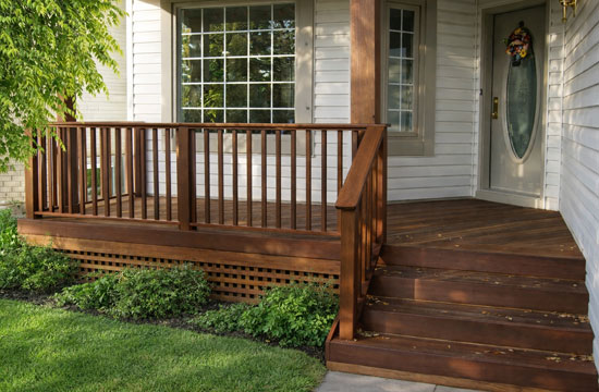 Hardwood front porch in Toronto with traditional design, wood railings and solid wood column
