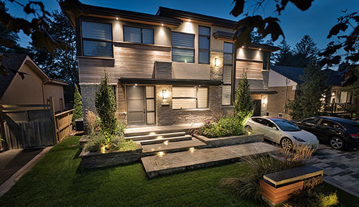 Modern front yard landscaping designed to complement a contemporary David Small–style home