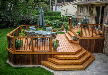 Classic cedar deck with partial walkout, compact main-floor deck, and larger stepped-down deck