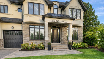 Natural stone front porch in Oakville with landscaped gardens and a stone pathway leading to the entrance.
