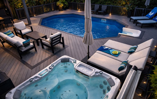 Custom Toronto backyard featuring on-ground pool, premium pool deck, integrated hot tub, and contemporary louvered pergola for privacy and style