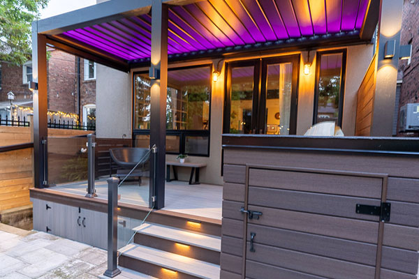 Fiberon composite deck with louvered pergola, glass railings and integrated lighting in High Park Toronto