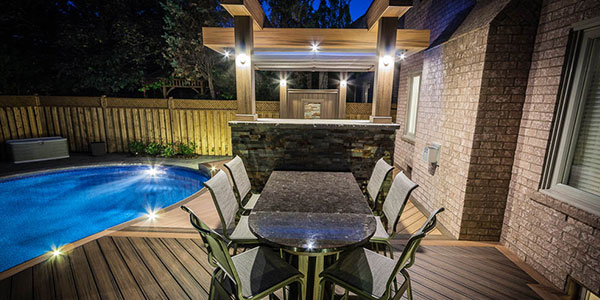 Composite deck with pergola and modern outdoor seating built by Toronto composite deck builder