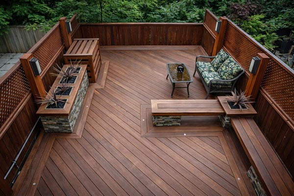 Ipe rooftop deck over parking garage at The Beaches featuring built-in benches, integrated planters, and recessed deck lighting
