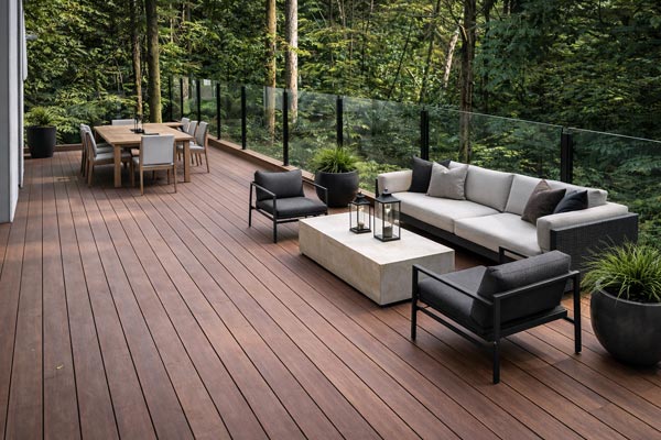 Modern Oakville rooftop deck with Ipe decking over a flat roof, featuring frameless glass railings and expansive views